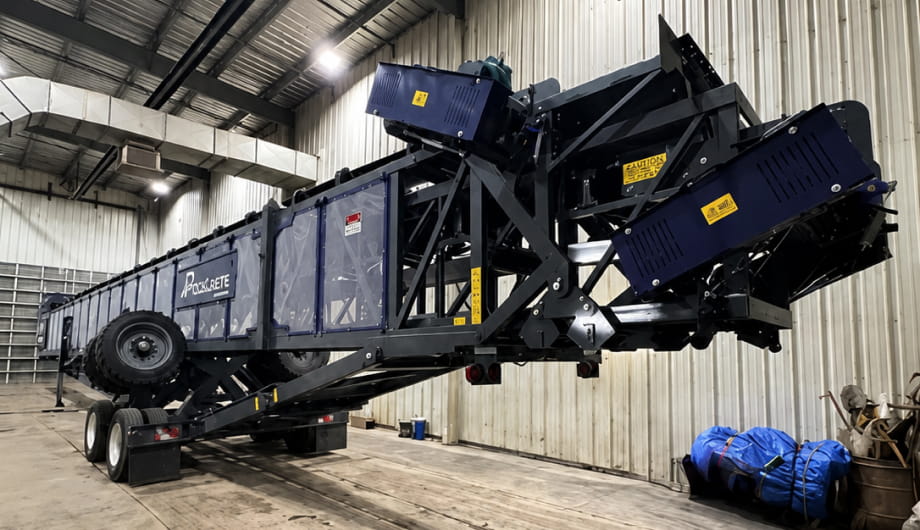 A large machine in operation, moving materials on a construction site.